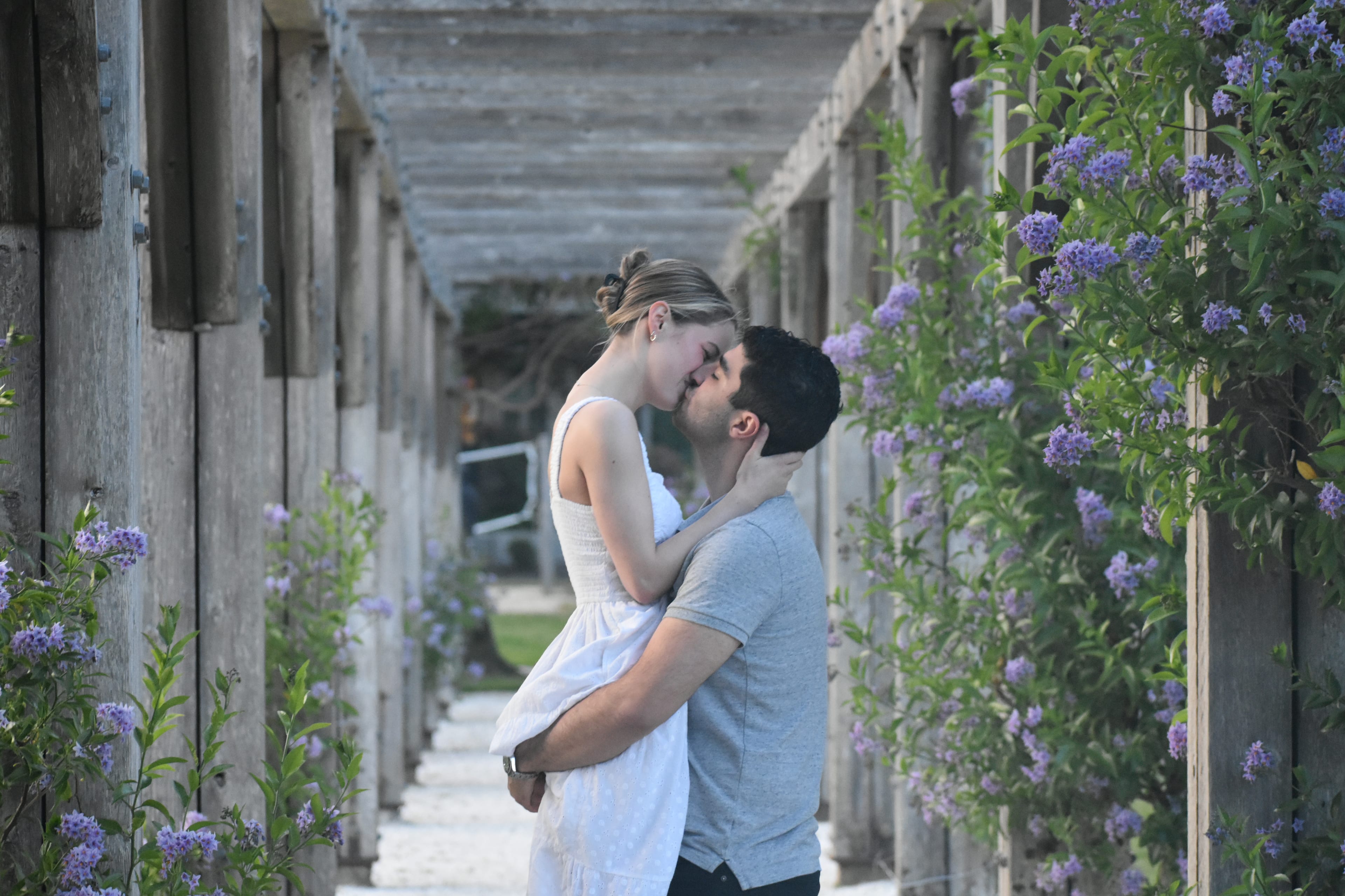 Johanna and Andrew under a flowering arbor